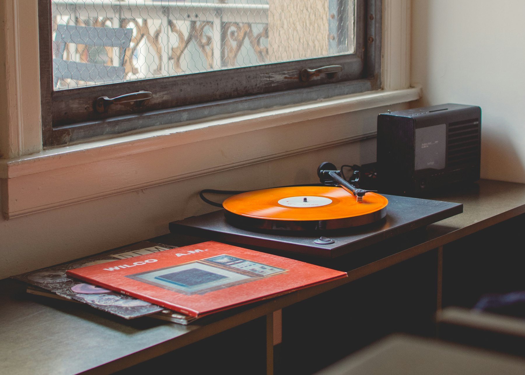A turntable playing, tonearm down on the record