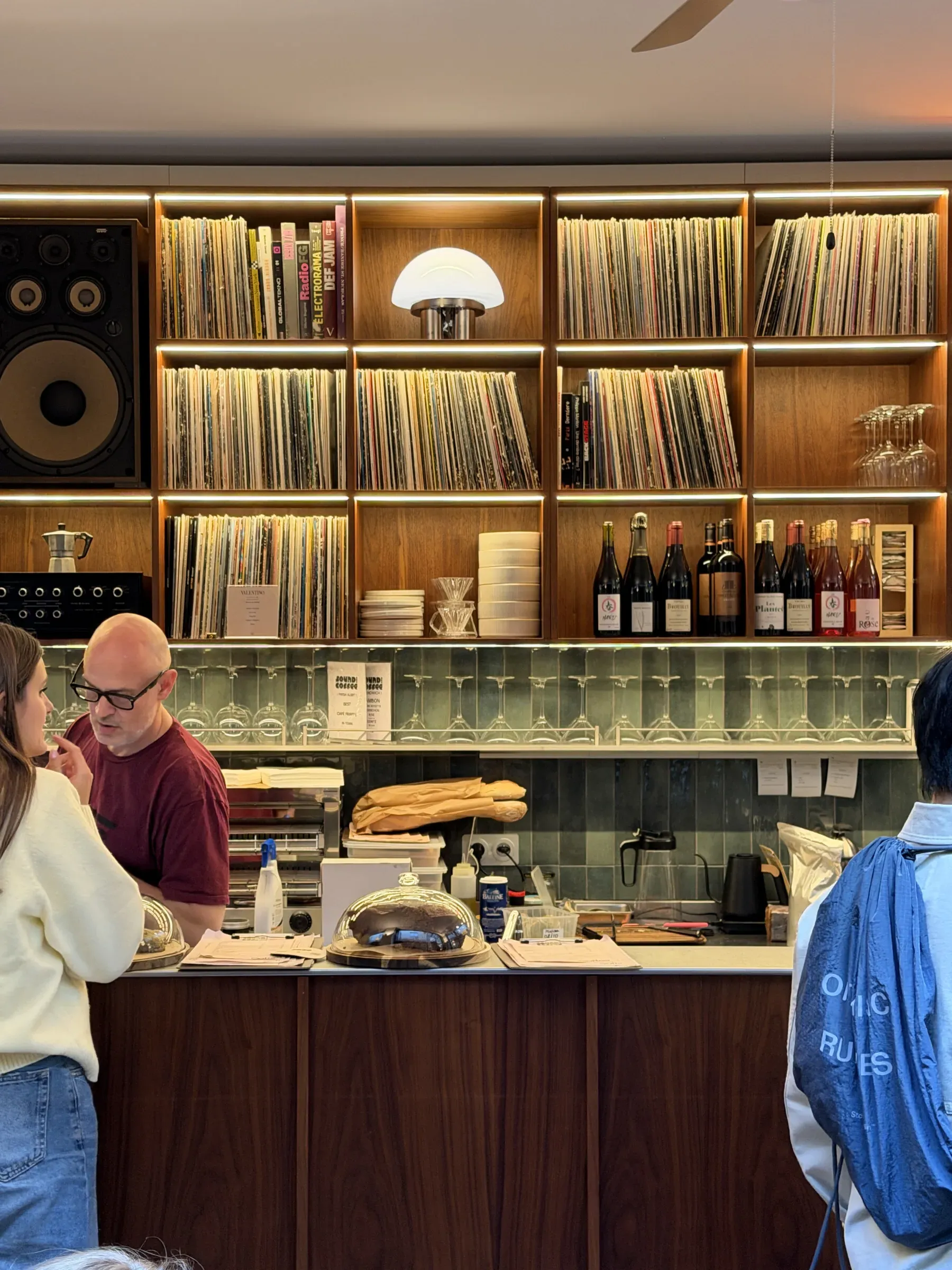 The counter at Sound and Coffee, Paris, with a wall of vinyl and a horn speaker above it