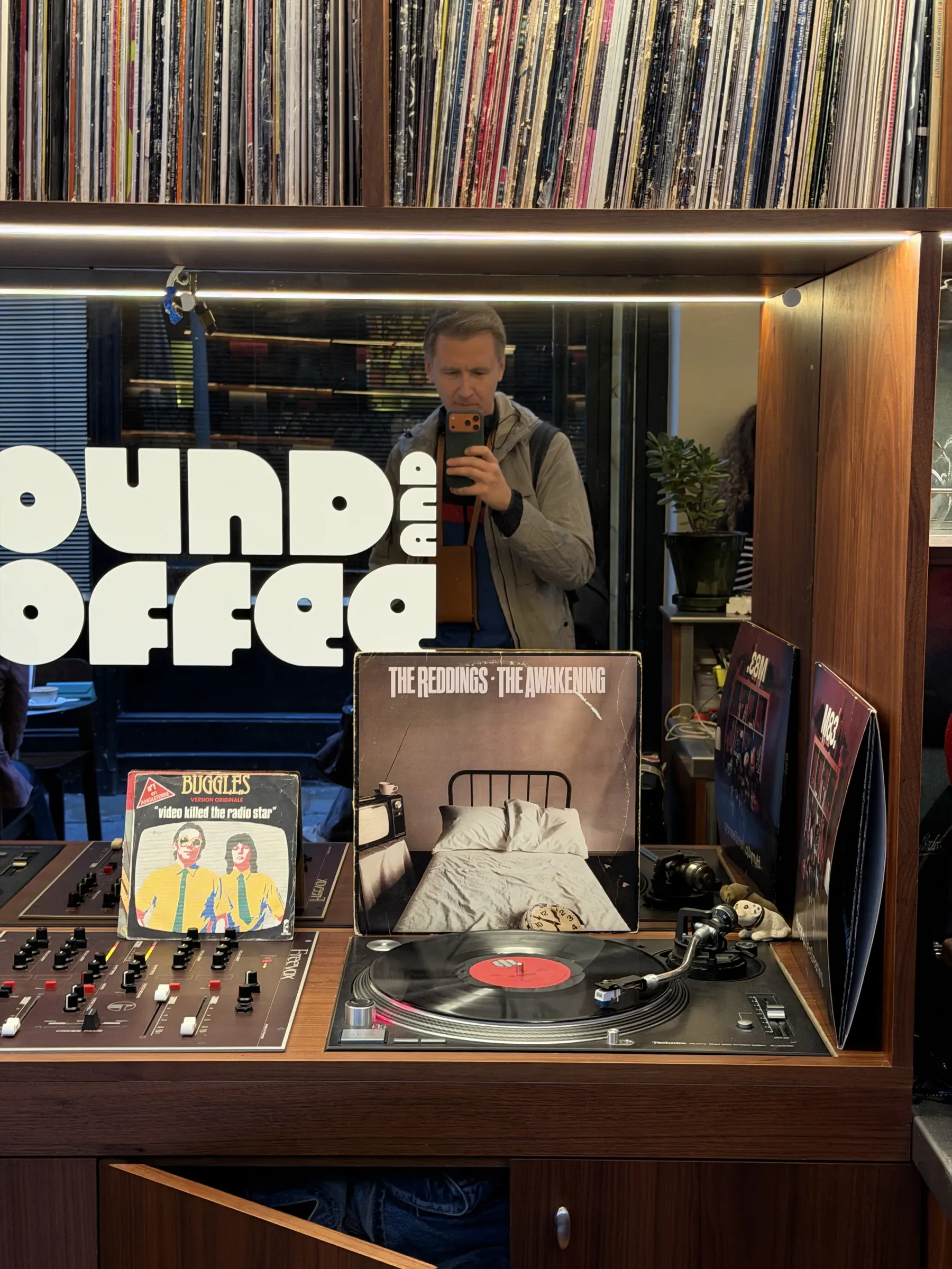 A record playing at Sound and Coffee, Paris, sleeves propped either side of the deck