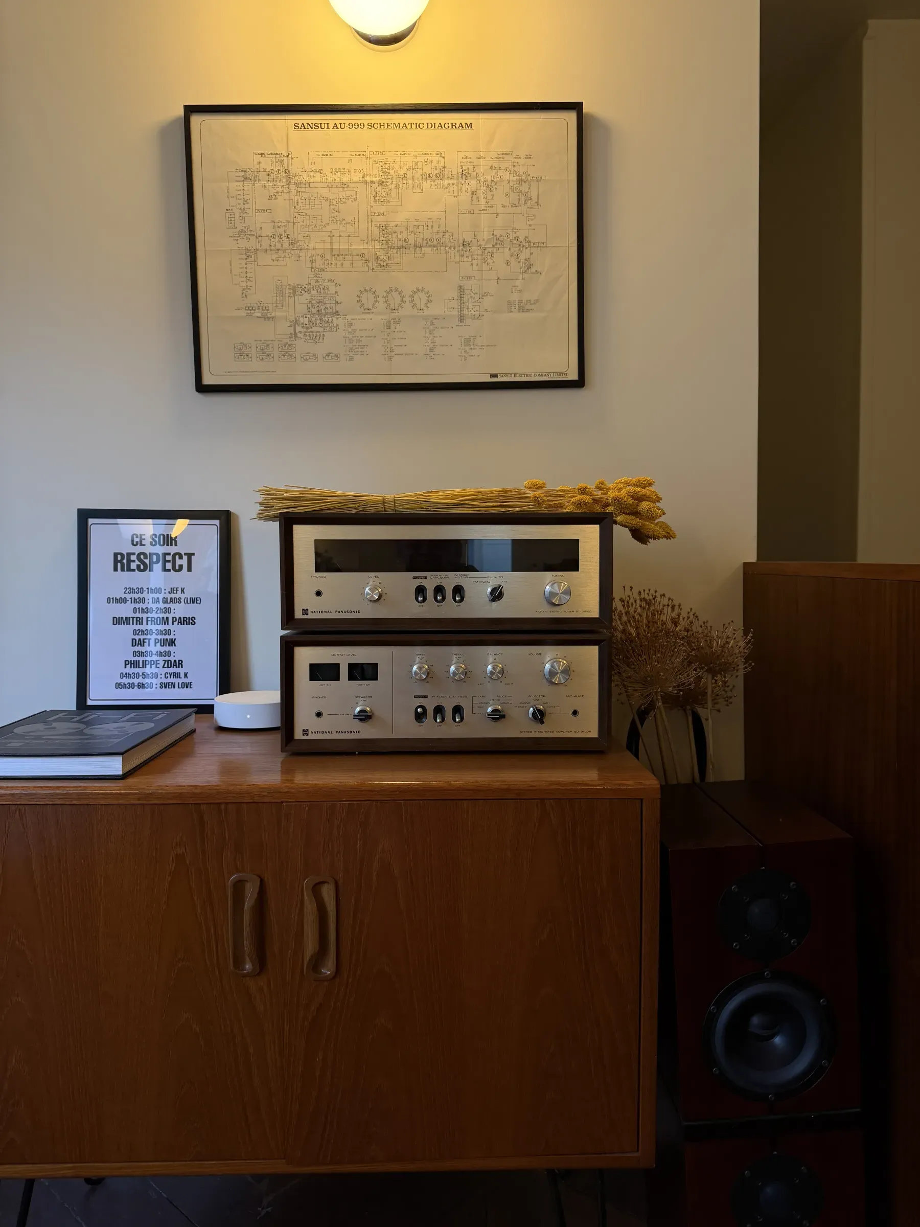Vintage amplifier and tuner on a teak sideboard beside a floor speaker at Sound and Coffee, Paris